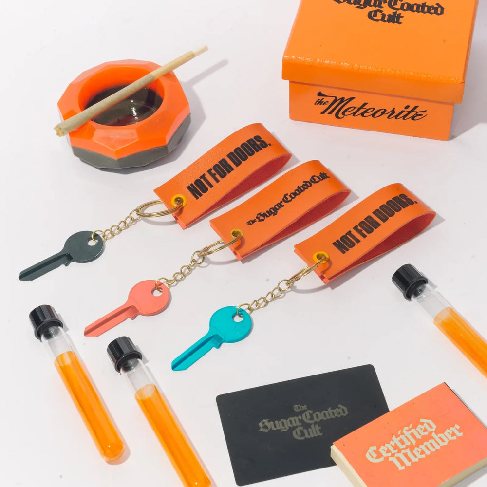 The range from above: the Meteorite, its box, three keyrings, tubes, the black card and the booklet