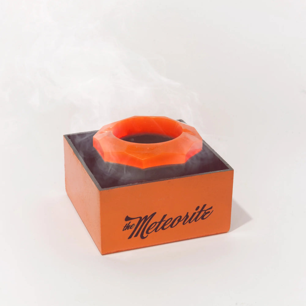 The Meteorite on its box with smoke drifting across