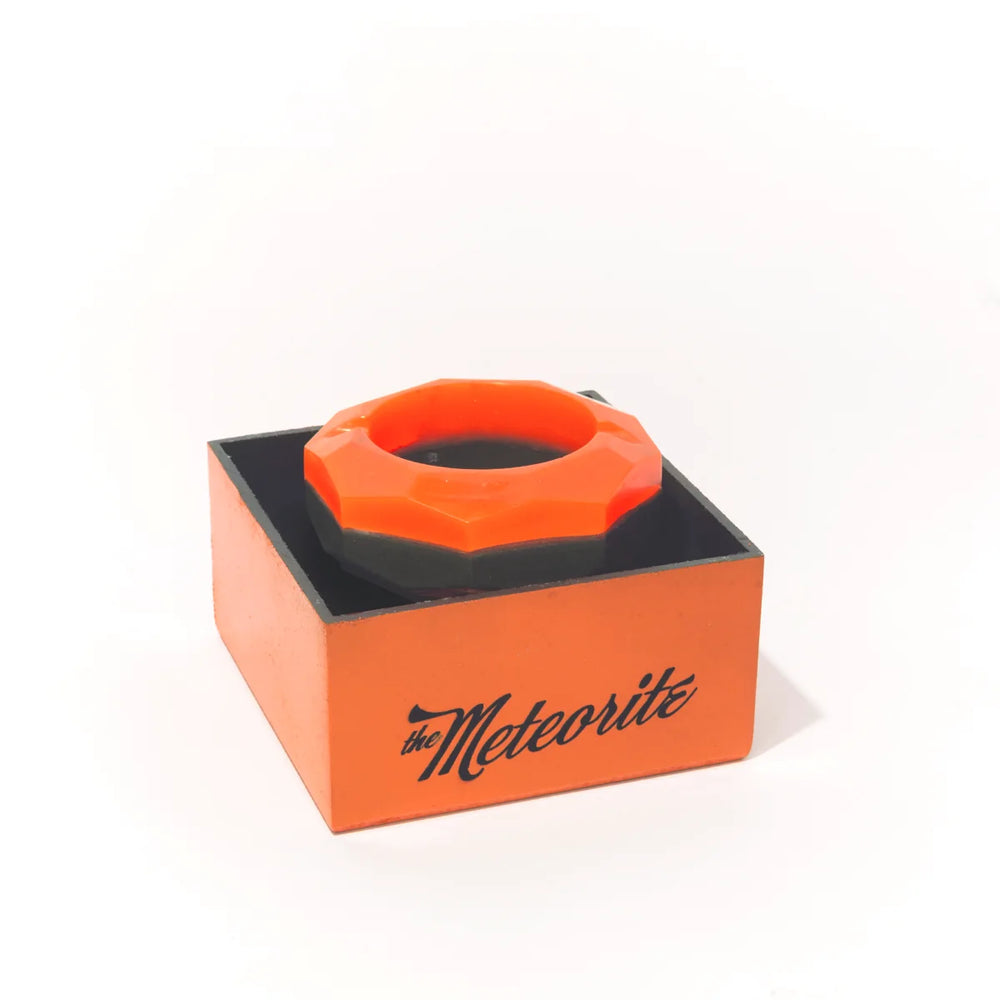 The Meteorite sitting on its open orange box, the name written on the side