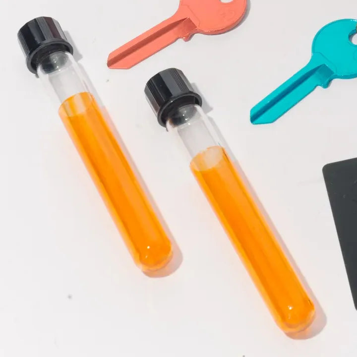 Two clear tubes with black screw caps and an orange inner tube