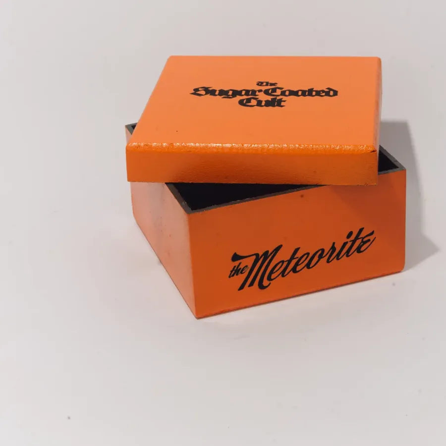 The Meteorite box, frame 2 of 6: the lid lifting