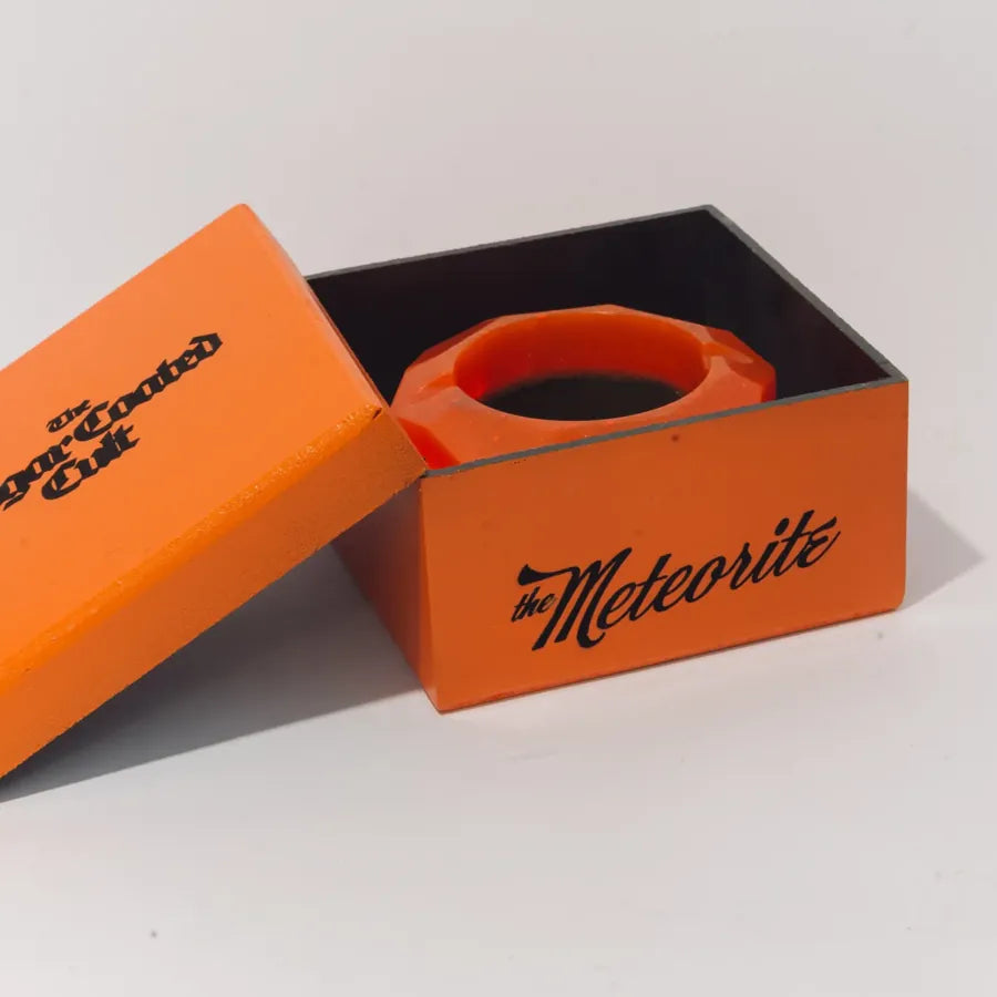 The Meteorite box, frame 4 of 6: the lid set aside